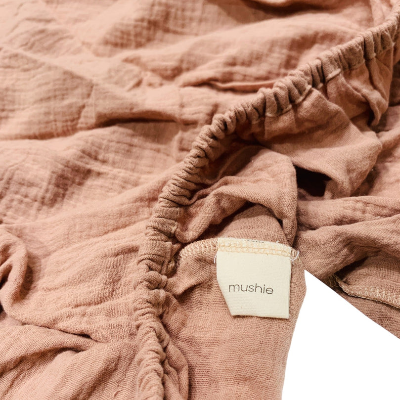 Mushie-Extra-Soft-Muslin-Crib-Sheet-in-Blush-1-3